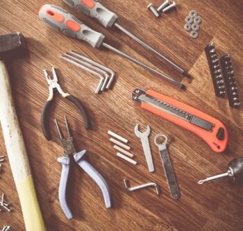 A wooden table with many different tools on it.