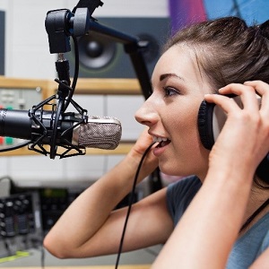 Here's an alt tag for the image: `Woman recording podcast in studio`