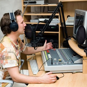 Here's an alt tag for the image: `Man broadcasting on radio show`